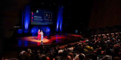 Claire Walker & Hannah Essex stood on stage giving a welcome speech.